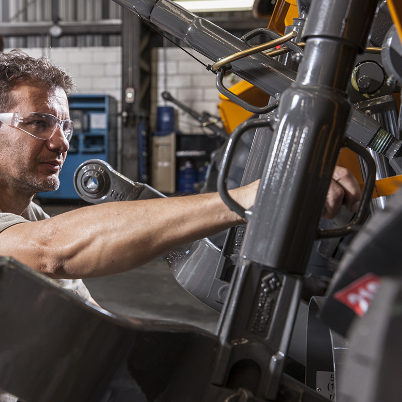 Man working on tractor engine